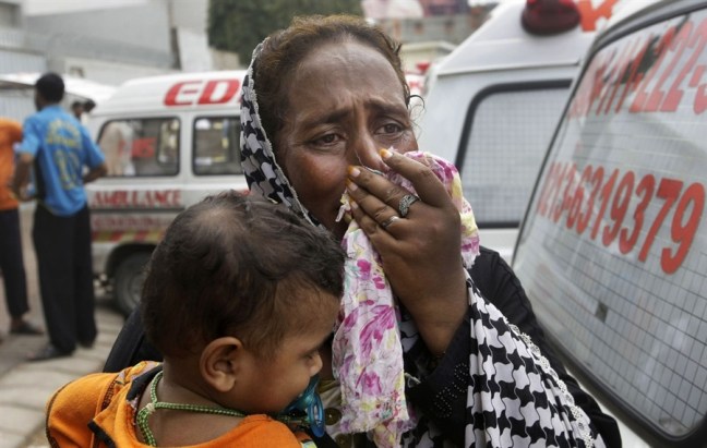 A woman mourns for a family member who was killed in the Karachi factory fire in September 2012. Photo from NBC News.